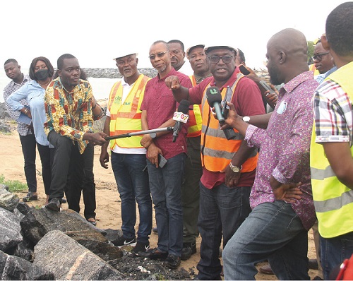 Osei Sarpong (2nd from right), Project Manager, Bridge Global, briefing the parliamentary select committee on the progress of work